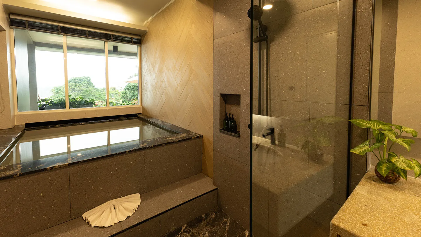 A lavish bathroom at Andaman Cannacia Resort & Spa featuring a private plunge pool and a modern shower area