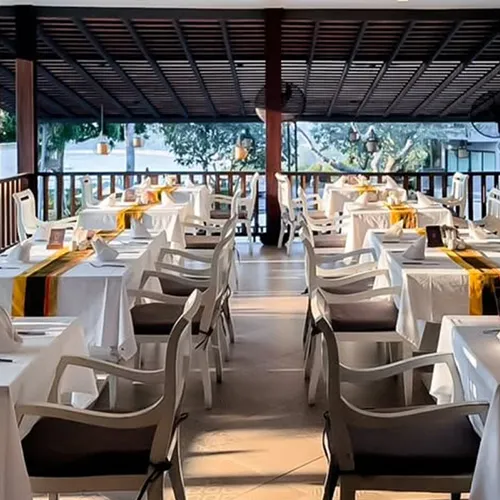 Dining setup with tables and chairs, showcasing the restaurant’s atmosphere overlooking Kata Beach